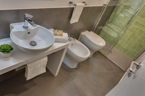 a bathroom with a sink and a toilet and a shower at Navona Theatre Hotel in Rome