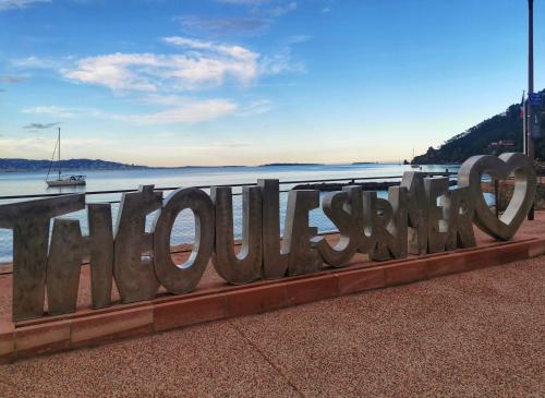 a large metal sign on the side of the water at Rousseau in Théoule-sur-Mer