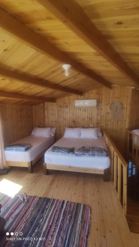 two beds in a room with a wooden ceiling at Panorama Lodge Nuweiba in Nuweiba