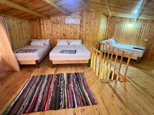 a room with two beds in a wooden cabin at Panorama Lodge Nuweiba in Nuweiba