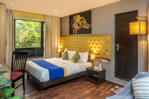 a bedroom with a bed and a living room at Hotel Orritel West in Mumbai