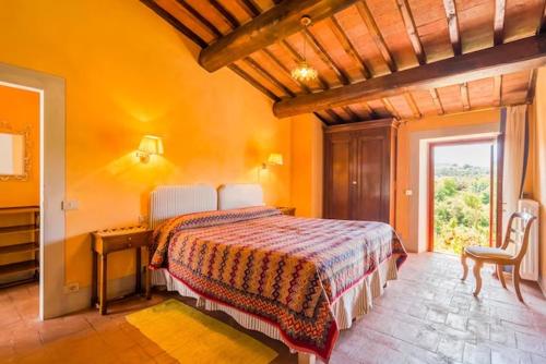 a bedroom with a bed in an orange room at Primerose in Greve in Chianti