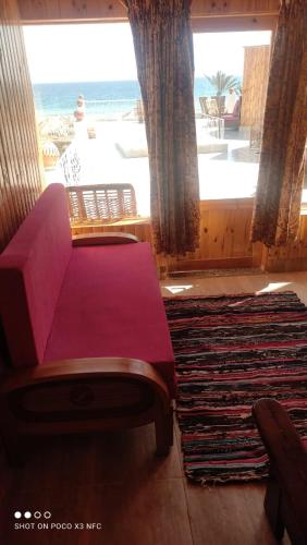 a living room with a couch and a large window at Panorama Lodge Nuweiba in Nuweiba