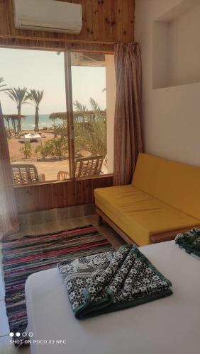 a room with two beds and a view of the beach at Panorama Lodge Nuweiba in Nuweiba