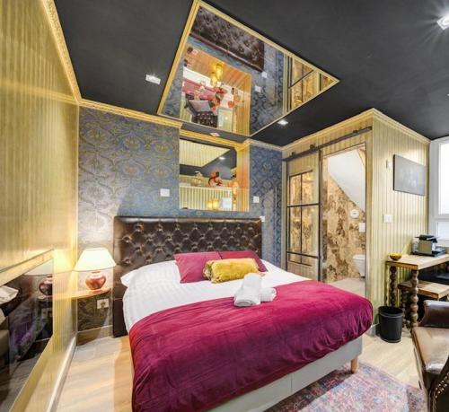 a bedroom with a large bed with a red blanket at Luxury Room in Dijon