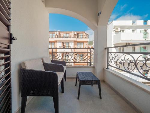 a balcony with chairs and a view of a building at Apartments Mary in Budva