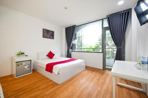 1 dormitorio con cama y ventana grande en PHÚ GIA BÙI VIỆN HOTEl, en Ho Chi Minh