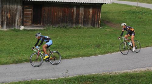 two people riding bikes down a road at Aparthouse Jana Breg in Žirovnica