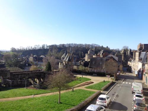 a small town with cars parked on a street at Le Relais Médiéval in Fougères