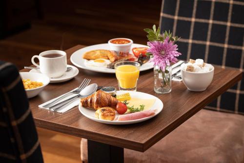 a table with two plates of breakfast food on it at Bank House Pitlochry in Pitlochry