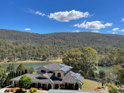 an aerial view of a house with a lake at Blackstone Lakeside 4 Bedrooms 2 Bathrooms in Hadspen