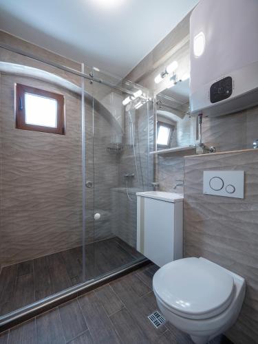 a bathroom with a toilet and a shower at Apartments Mary in Budva