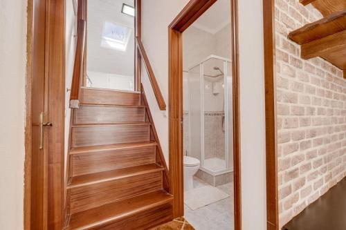a bathroom with a staircase leading to a toilet at Casinha Da Igreja in Igrejinha