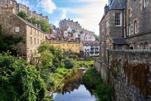 a river in the middle of a city with buildings at Safestay Edinburgh Cowgate in Edinburgh