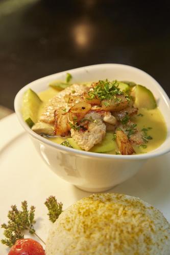 a bowl of soup on a table with a plate of food at Rebgarten Hotel Adler in Pfullendorf