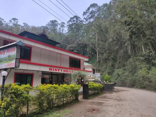 a building on the side of a dirt road at Misty Hills Munnar in Munnar