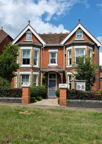 a brick house with a sign in front of it at Cannara B and B in Great Malvern
