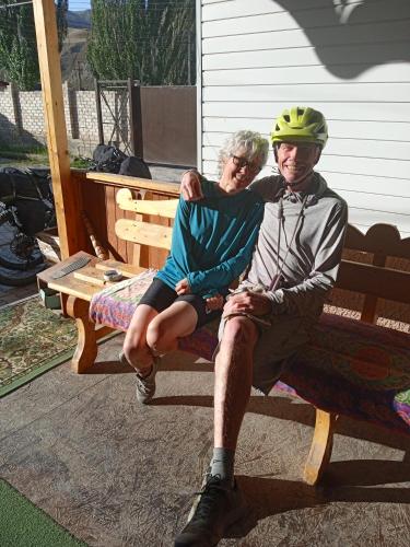 a man and a woman sitting on a bench at Baktygul guesthouse in Naryn