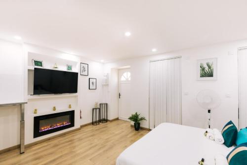a white room with a bed and a fireplace at GuestReady - Amazing Studio near Disneyland in Montévrain