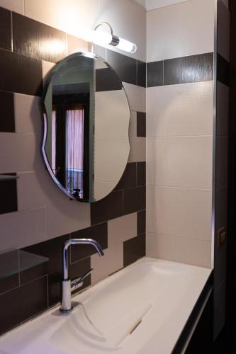 a bathroom with a sink and a mirror at Rifugio Guglielmini Centrale in Domodossola