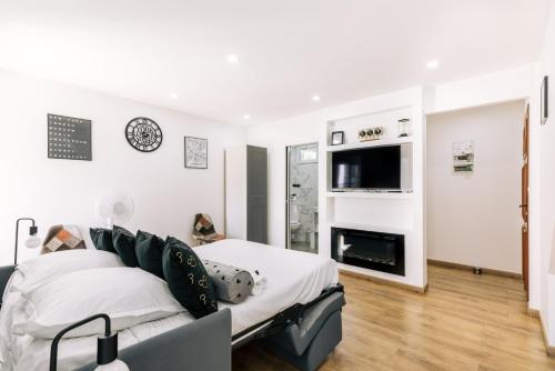 a living room with a bed and a fireplace at GuestReady - Amazing Studio near Disneyland in Montévrain
