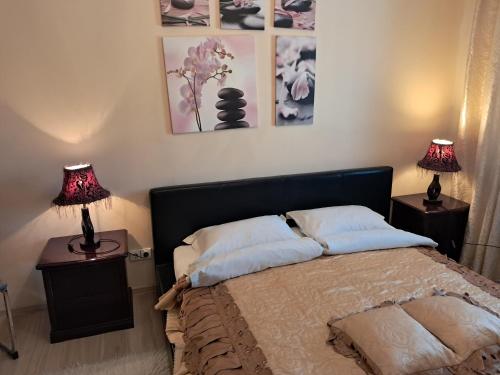a bedroom with a bed with two lamps on tables at 3min walk to Vilnius business center in Vilnius