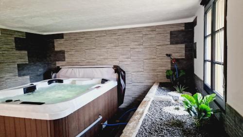 a bath tub in a room with at Revauche et spa in Fresse-sur-Moselle