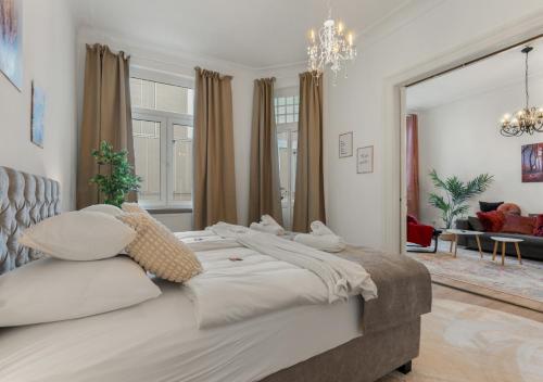 a bedroom with a large bed and a living room at LoC-Oldenburg Altstadt in Oldenburg