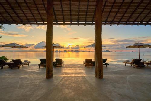 a view of a beach with chairs and umbrellas at Six Senses Yao Noi in Ko Yao Noi