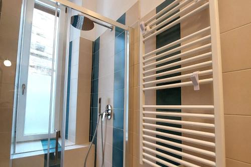 a bathroom with a shower and a window with shutter at Residenza Maritti Classic Rooms in Rome