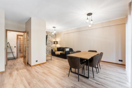 a living room with a table and chairs and a couch at GuestReady - A breath of fresh air in Nogueiró 