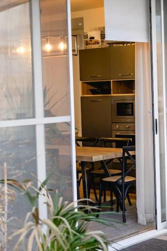 a dining room with a table and a kitchen at Luxurious & Stylish Penthouse with Private Pool in Msida