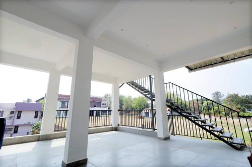 a balcony with a staircase in a building at Eazy Homes in Palakkad