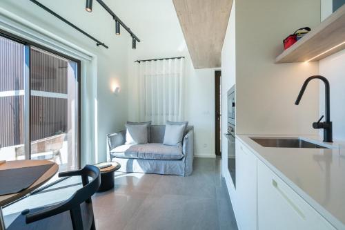 een keuken en een woonkamer met een bank en een tafel bij GuestReady - Quinta Leitão 3 in Anissó