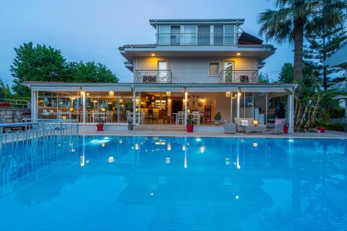 a large swimming pool in front of a house at HOTEL DALYANCE in Dalyan