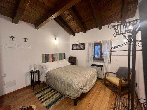 a bedroom with a bed in a room with a ladder at Ca-Jo Bed and Breakfast in Garessio