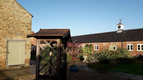 a wooden structure in front of a brick building at Castle Court in York