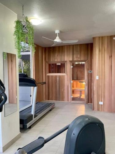 a room with a gym with a mop and a treadmill at Paradise Island Resort & Gardens - Gold Coast Surfers Paradise in Gold Coast