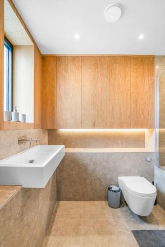 a bathroom with a sink and a toilet at Tottenham- Exquisite 4-Bed Retreat with Ping Pong and Pool - Sleeps 7, Free Parking, Contractors & Long Stays Welcome in London