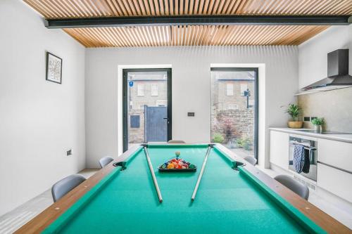 a dining room with a pool table in it at Tottenham- Exquisite 4-Bed Retreat with Ping Pong and Pool - Sleeps 7, Free Parking, Contractors & Long Stays Welcome in London