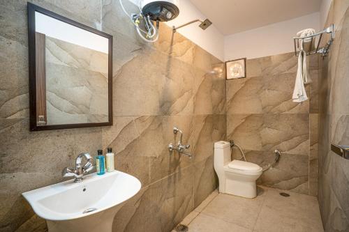 a bathroom with a sink and a toilet at Hotel Franklein Suites At Delhi Airport in New Delhi