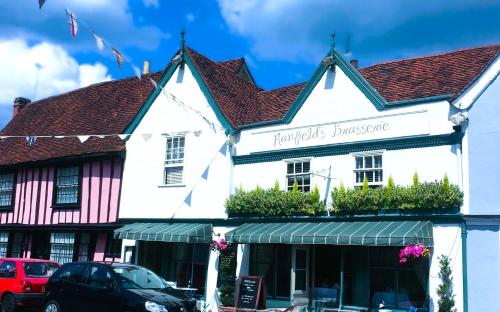 a white building with a sign that reads parrots bookstore at Ranfield's Brasserie Hotel Rooms in Coggeshall