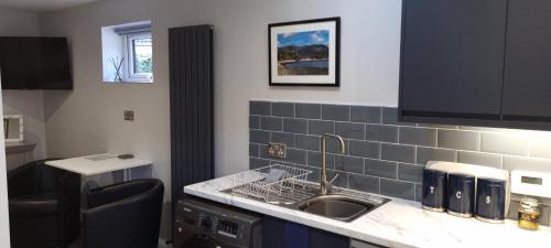 a kitchen with a sink and a counter top at The Nook in Rostrevor