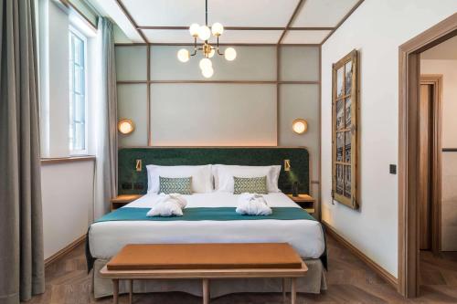 a bedroom with a large bed with two towels at Canfranc Estación, a Royal Hideaway Hotel - Gran Lujo in Canfranc-Estación
