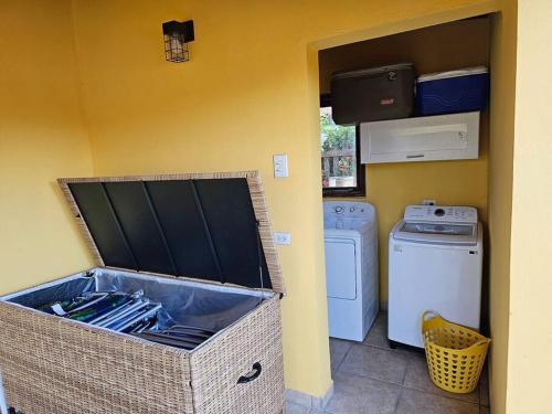 a laundry room with a washer and dryer at Yellow Cunucu-4 Bedrooms House in Paraguaná