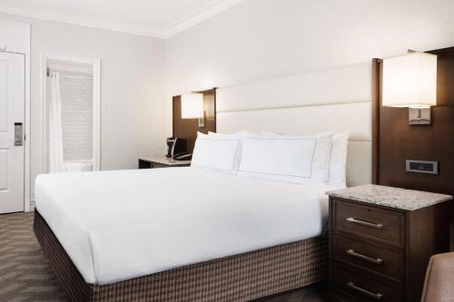 a large white bed in a hotel room at Hilton Boston Park Plaza in Boston