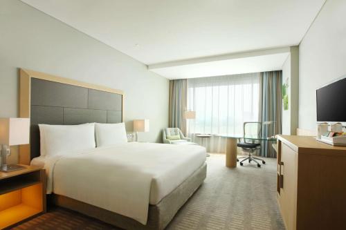 a hotel room with a bed and a desk at DoubleTree by Hilton Jakarta Kemayoran in Jakarta