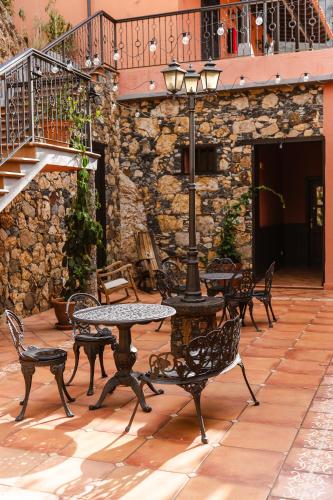 a patio with tables and chairs and a street light at Tamahuche Hotel Rural in Vallehermoso