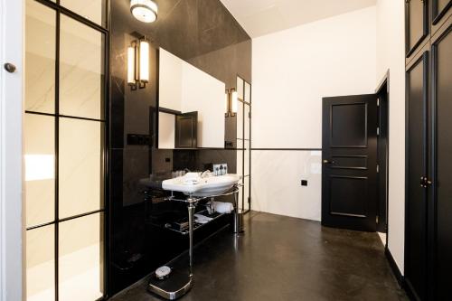 a bathroom with a sink and a mirror at Boutique Hotel Casa Cánovas in Cádiz