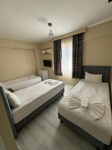 a bedroom with two beds with bows on them at Hotel Wiva in Istanbul